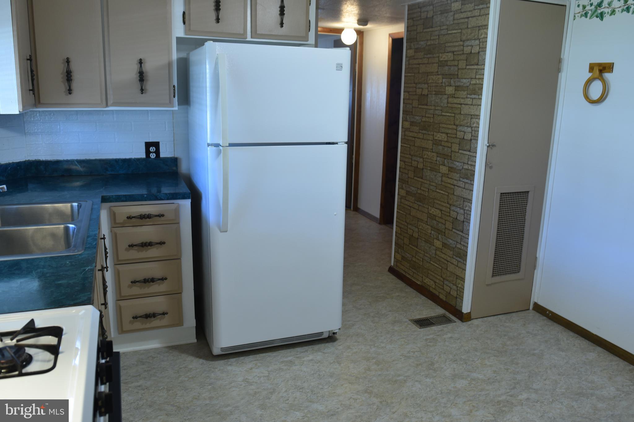 2764 North Clear Ridge Road Hustontown, PA 17229 - Photo 5 of 12 a white refrigerator freezer sitting in a kitchen