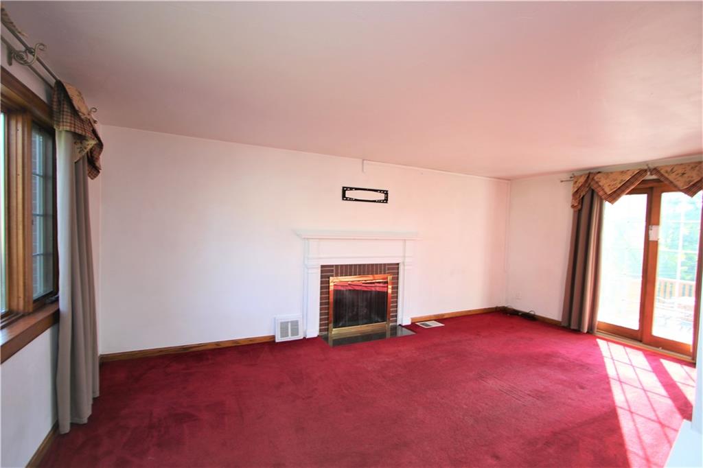 5319 Highgrove Road Whitehall, PA 15236 - Photo 2 of 24 LARGE 19x12 Living Room w/ Gas Fireplace accented by Brick Front and Marble Base, Oak Baseboard & Sliding Glass Door to Double Tiered Deck overlooking Awesome Back Yard!