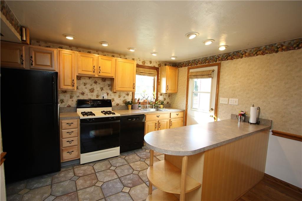 5319 Highgrove Road Whitehall, PA 15236 - Photo 3 of 24 Beautiful 19x12 Open Kitchen w/ Breakfast Bar, Plenty of Maple Wood Cabinets accented by Attractive Handles, Patterned Ceramic Tiled Floors, Recessed Lighting and all Appliances Included! Door leads to Small Deck