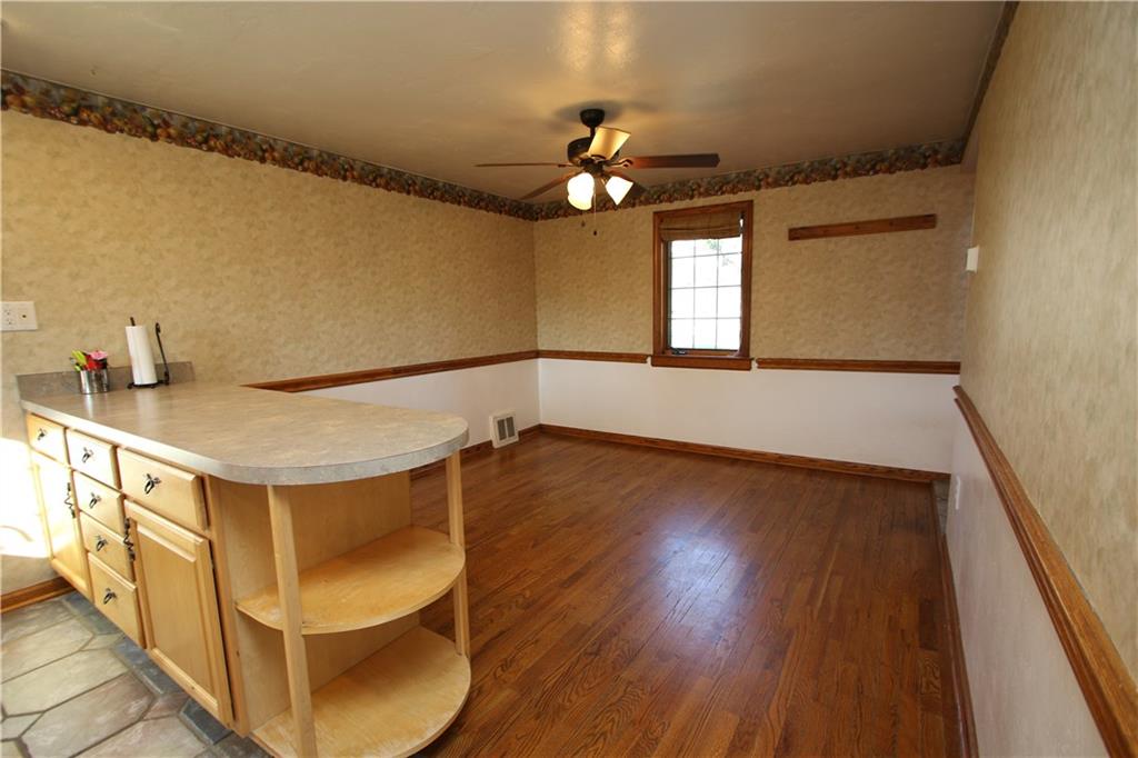 5319 Highgrove Road Whitehall, PA 15236 - Photo 4 of 24 Beautiful Hardwood Floors in Dining Room area highlighted w/ Oak Chair Rail Trim & Baseboard plus Ceiling Fan Light