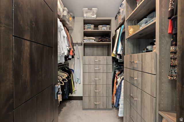 11547 Soaring Hawk Lane Hideout, UT 84036 - Photo 27 of 43 Custom closet system featuring dark wood-finish cabinetry, light wood-finish shelving, and integrated drawer storage with brushed metal pulls