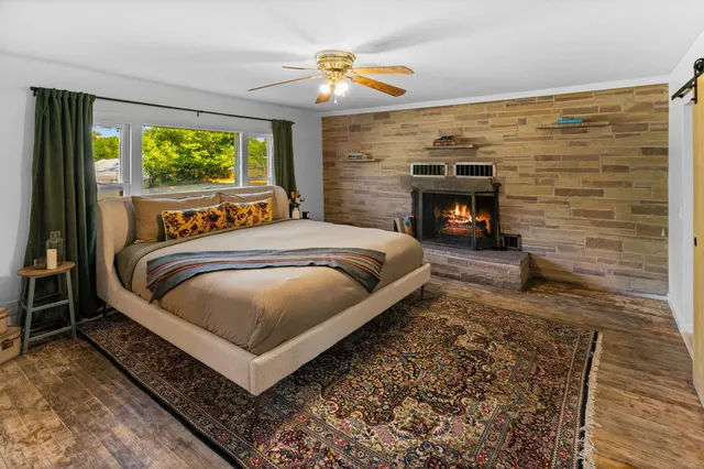 a bed sitting in a bedroom next to a window