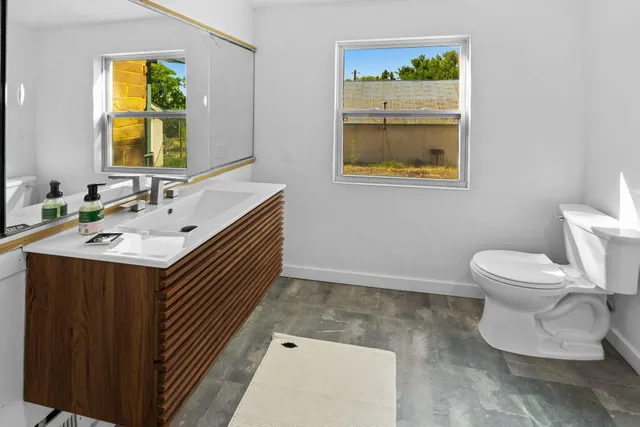 a bathroom with a sink a mirror and a toilet