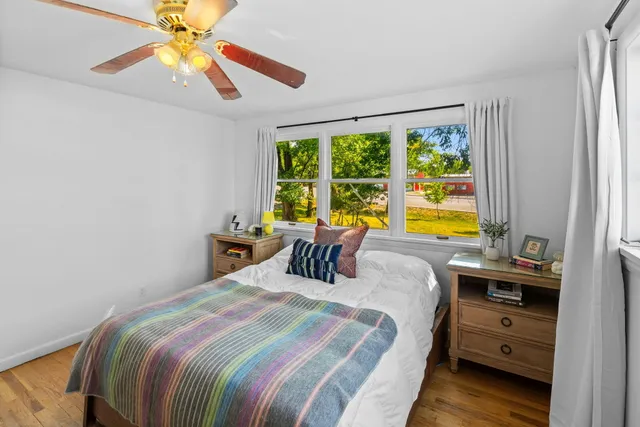 a bedroom with a bed and a desk