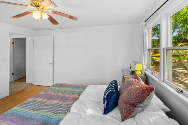 a bedroom with a bed and a window