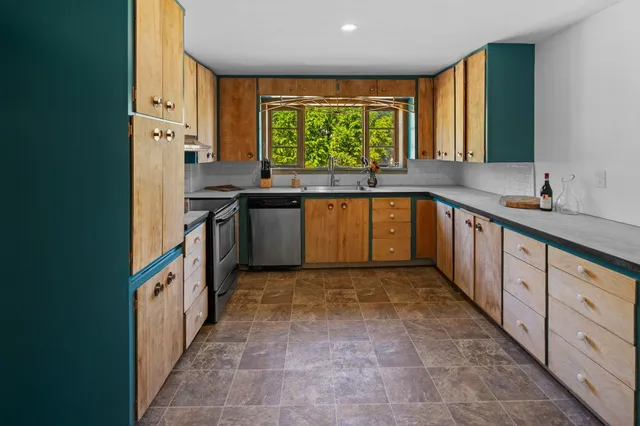 a kitchen with stainless steel appliances a sink and a stove