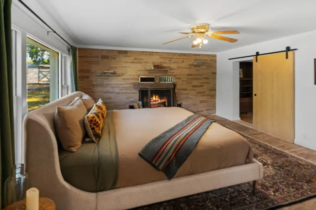 a bed sitting in a bedroom next to a window