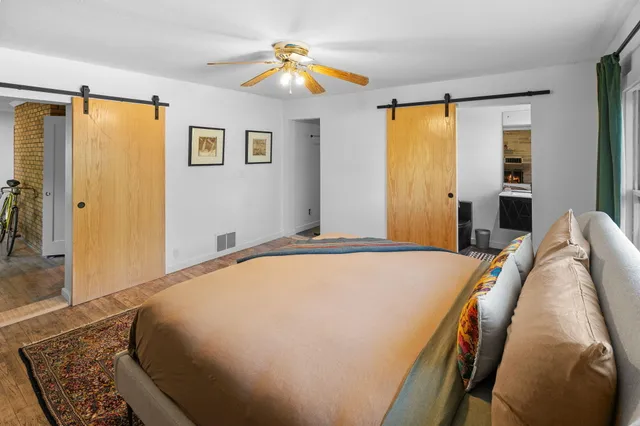 a bedroom with a bed and a chandelier