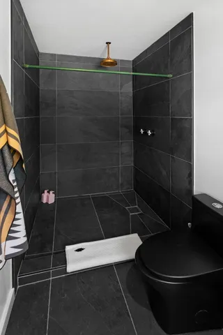 a bathroom with a shower toilet and a sink