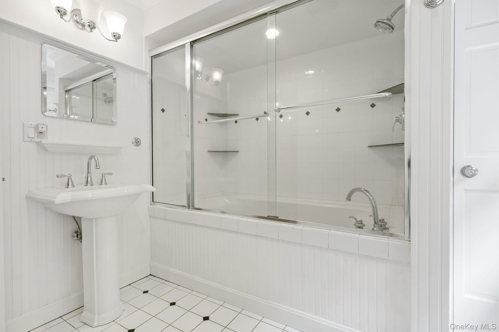 777 Armonk Road Mount Kisco, NY 10549 - Photo 31 of 44 Bathroom featuring combined bath / shower with glass door and tile patterned flooring