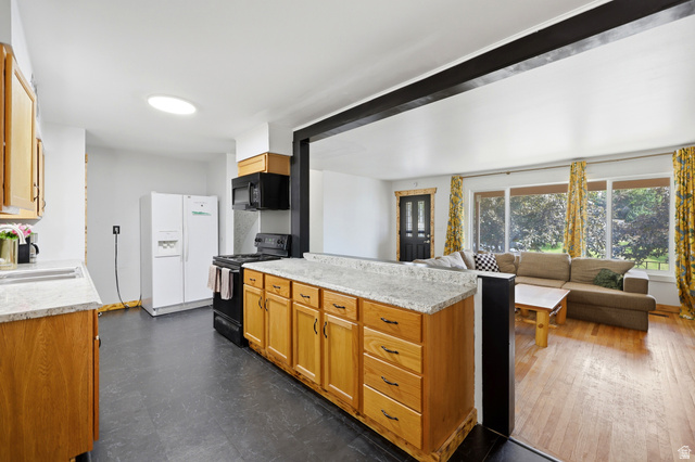 1486 3rd Street Ogden, UT 84404 - Photo 6 of 26 Kitchen island with light-toned cabinetry and a speckled countertop