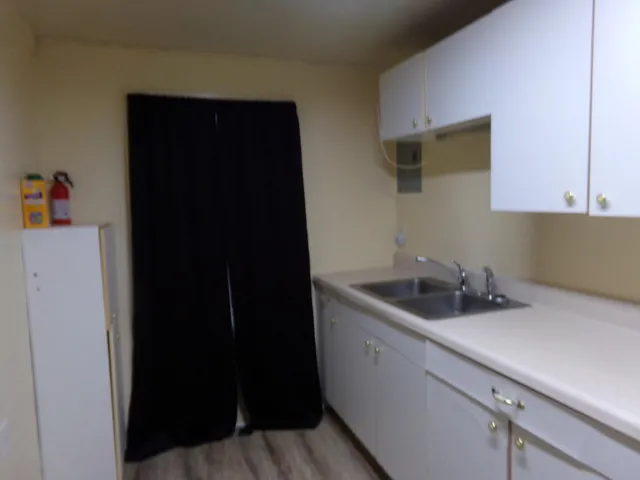 a kitchen with a sink and cabinets
