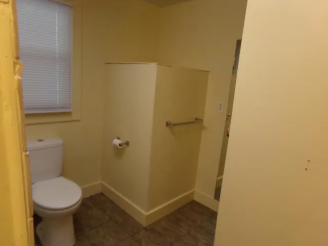 a bathroom with a toilet and a shower