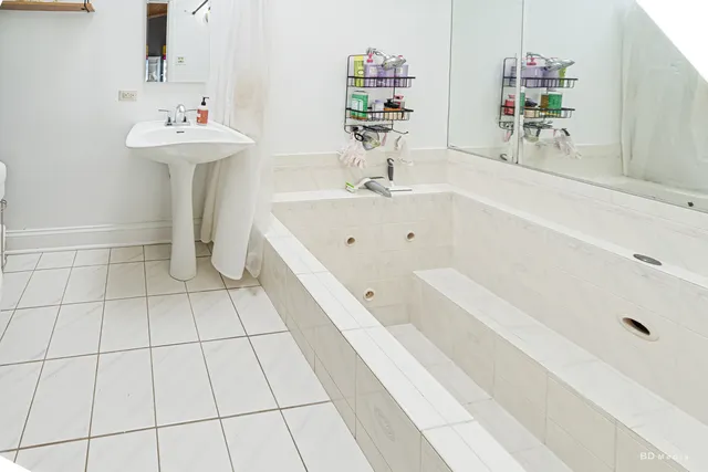 a bathroom with a bathtub and a sink
