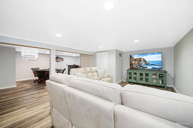 a living room with furniture a large window and a flat screen tv