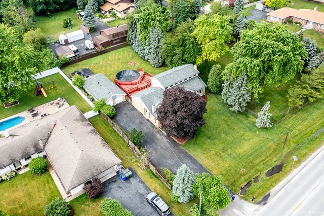 an aerial view of a house with a garden and swimming pool
