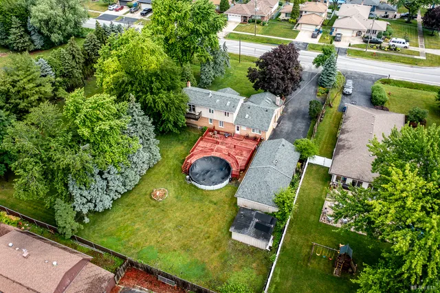 an aerial view of a house with yard swimming pool and outdoor seating