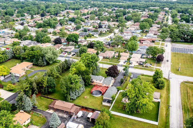 an aerial view of residential houses with outdoor space and street view