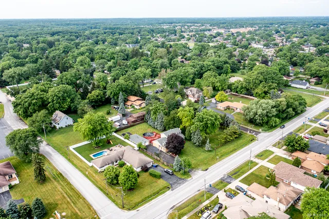an aerial view of a house with a yard