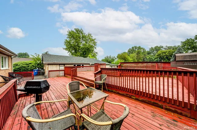 a view of a roof deck with wooden floor and fence