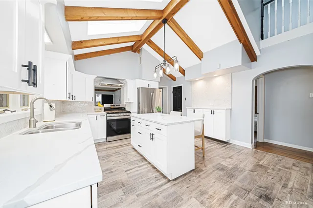 a kitchen with white cabinets and white appliances