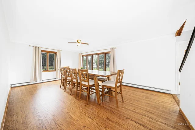 a dining room with furniture and wooden floor
