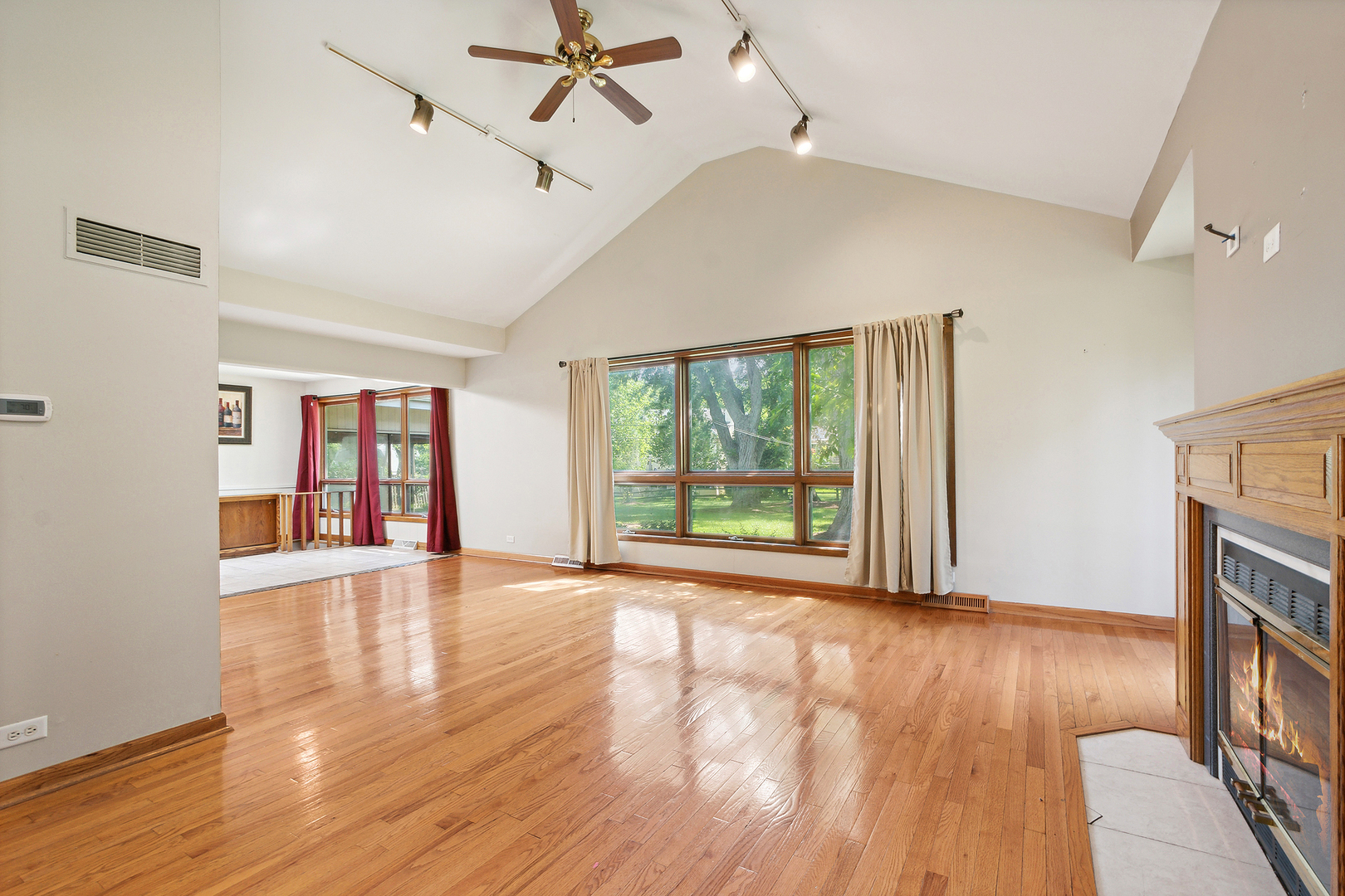 509 Hawthorne Road Frankfort, IL 60423 - Photo 12 of 36 a view of an empty room with wooden floor fireplace and a window