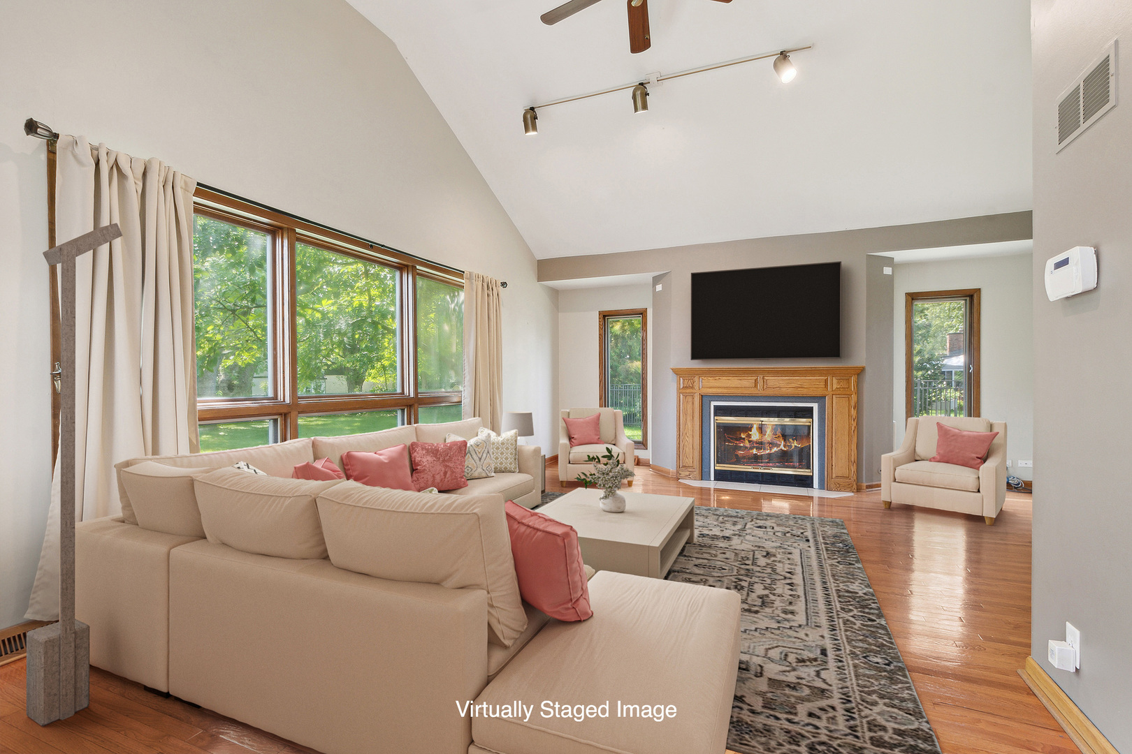 509 Hawthorne Road Frankfort, IL 60423 - Photo 9 of 36 a living room with furniture a fireplace and a flat screen tv