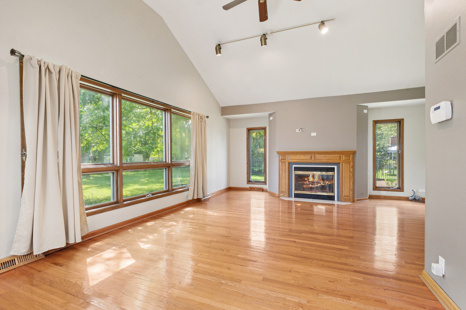 509 Hawthorne Road Frankfort, IL 60423 - Photo 10 of 36 a view of an empty room with a window and wooden floor