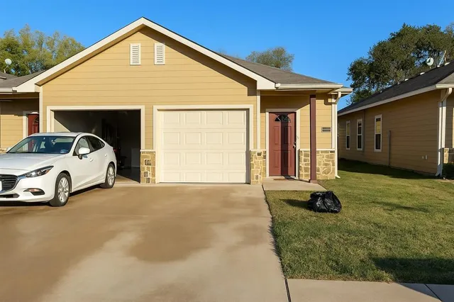 a view of a house with a yard and garage
