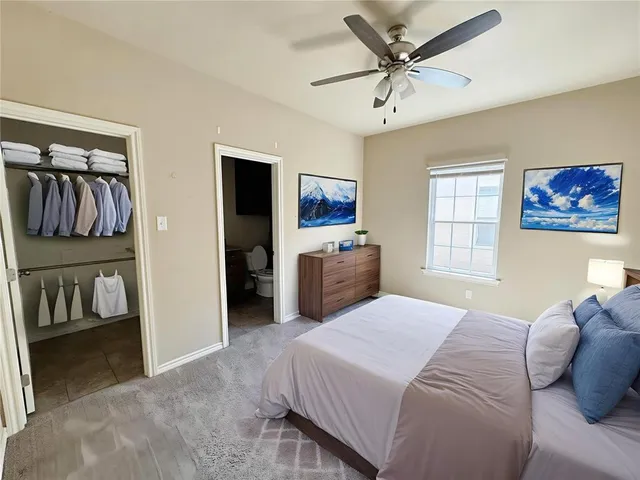 a bedroom with a bed and a painting on the wall