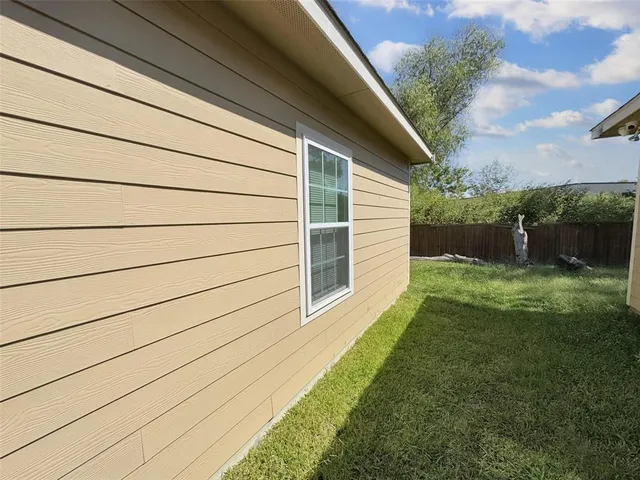 a view of house with backyard