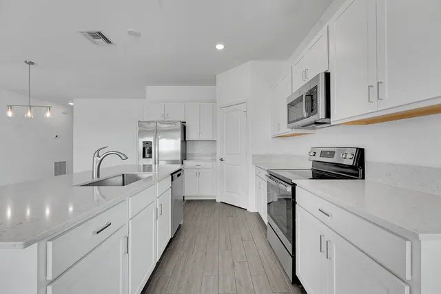 a view of an empty room with closet and cabinet