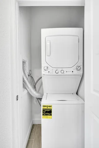 a spacious bedroom that has a bed and a potted plant