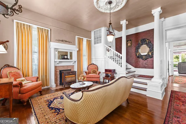 a living room with furniture and a chandelier