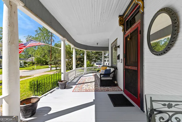 a view of a patio with a table chairs and a yard