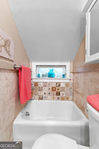 a bedroom with a bed and a television