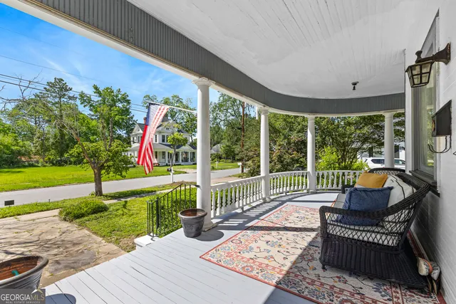 a view of swimming pool with lawn chairs and couches