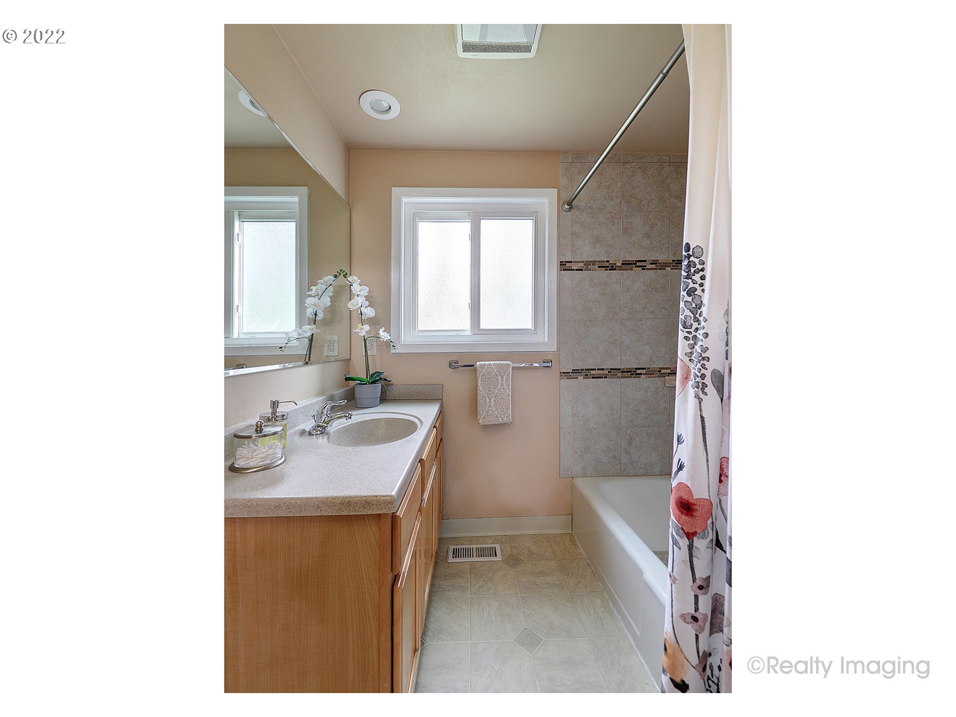 13936 Southeast Taylor Street Portland, OR 97233 - Photo 11 of 24 a bathroom with a sink a mirror and a bath tub