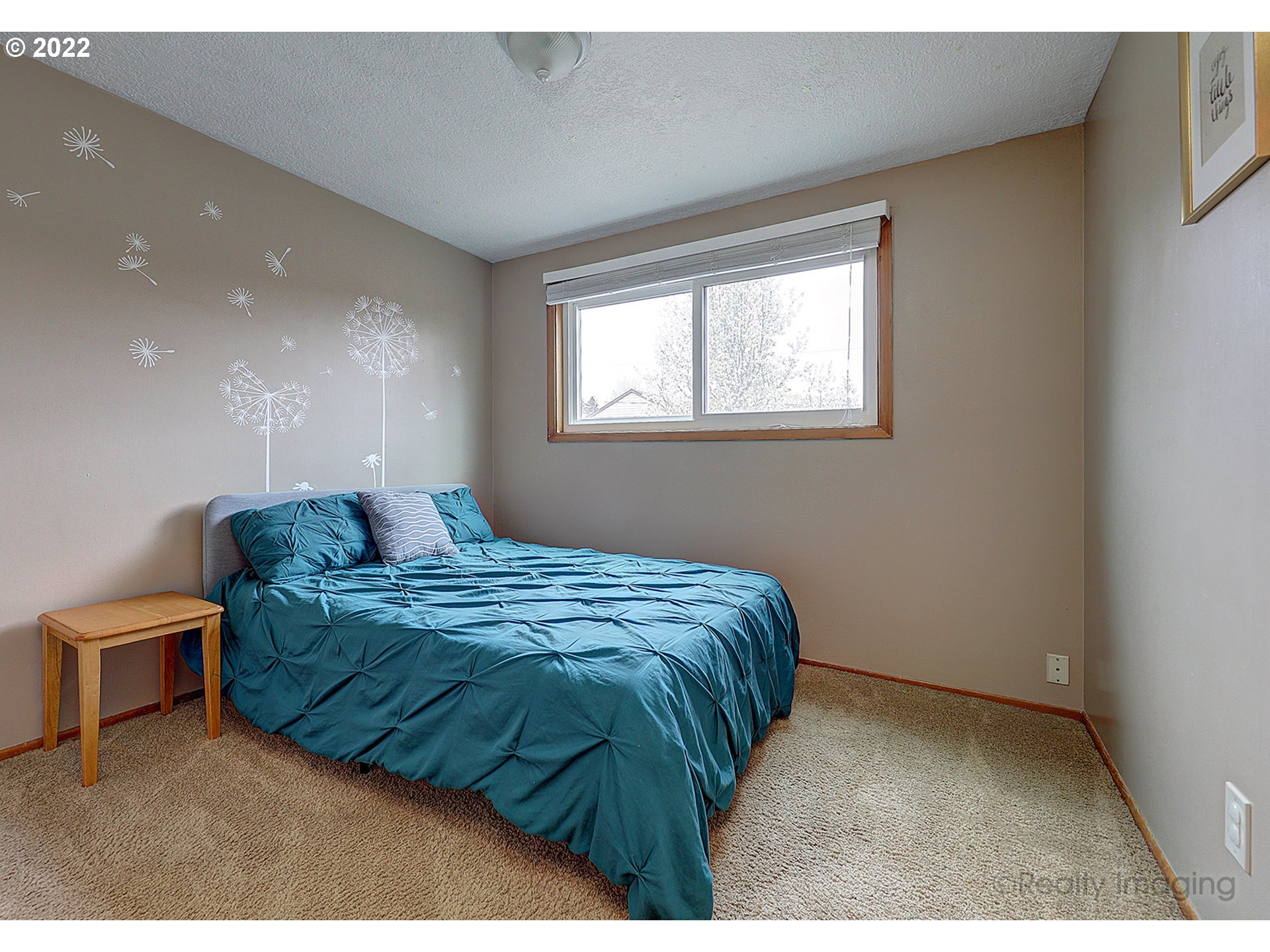 13936 Southeast Taylor Street Portland, OR 97233 - Photo 12 of 24 a bed sitting in a bedroom next to a window