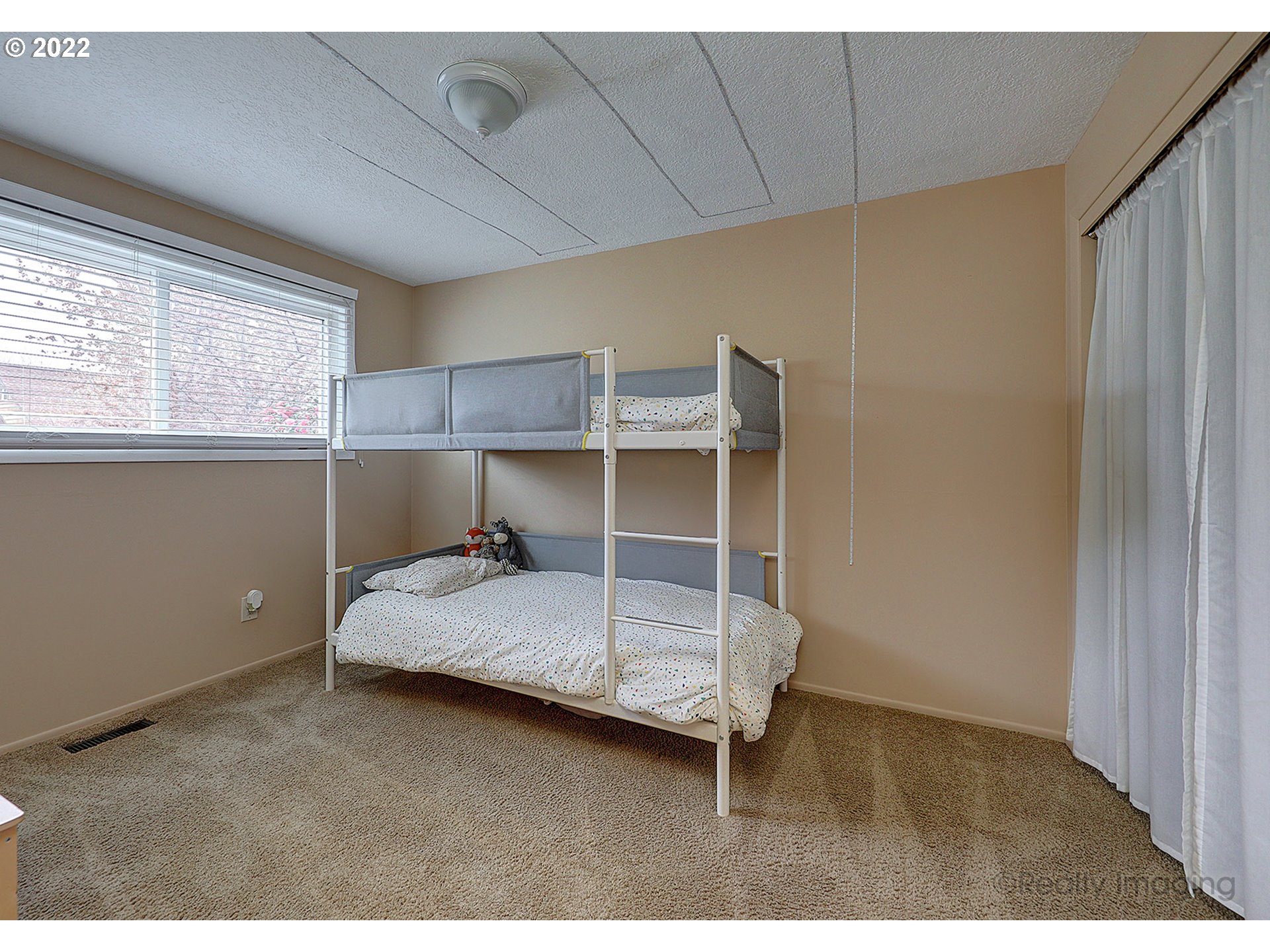 13936 Southeast Taylor Street Portland, OR 97233 - Photo 13 of 24 a bedroom with a bed and a window