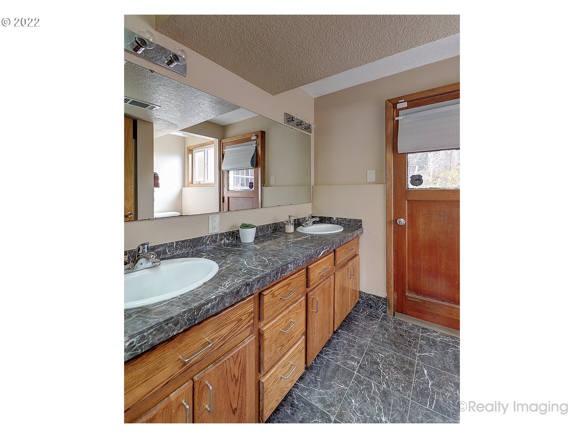 13936 Southeast Taylor Street Portland, OR 97233 - Photo 17 of 24 a bathroom with a granite countertop sink and a mirror