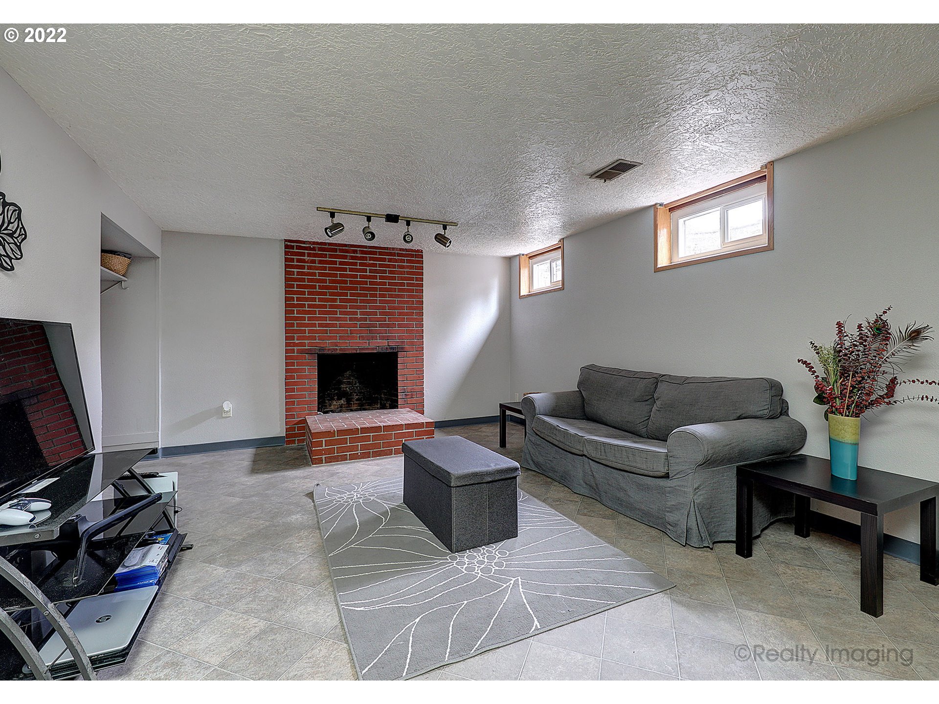 13936 Southeast Taylor Street Portland, OR 97233 - Photo 18 of 24 a living room with furniture and a fireplace