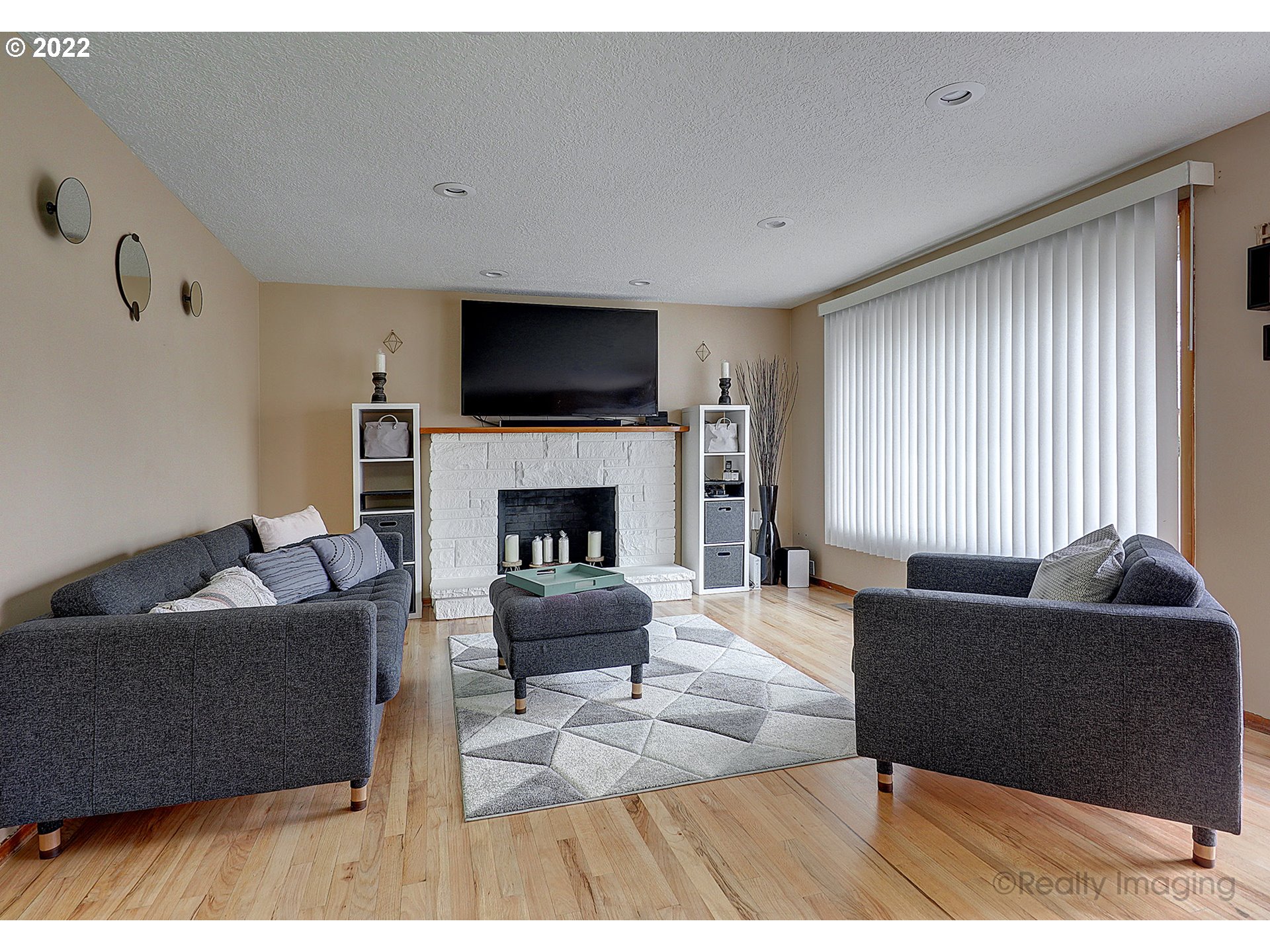 13936 Southeast Taylor Street Portland, OR 97233 - Photo 4 of 24 a living room with furniture a flat screen tv and a fireplace
