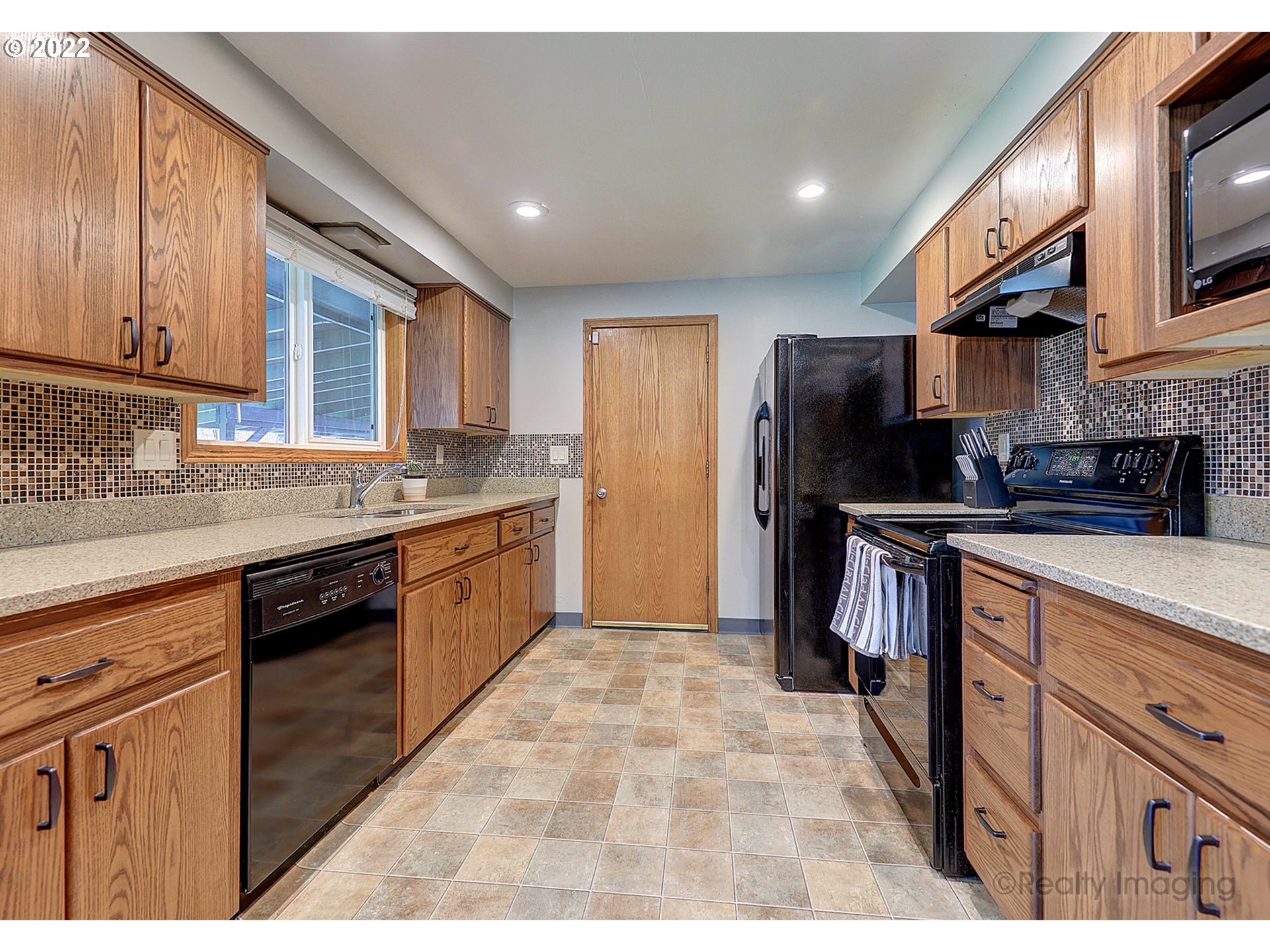 13936 Southeast Taylor Street Portland, OR 97233 - Photo 7 of 24 a kitchen with stainless steel appliances granite countertop a refrigerator and a stove top oven