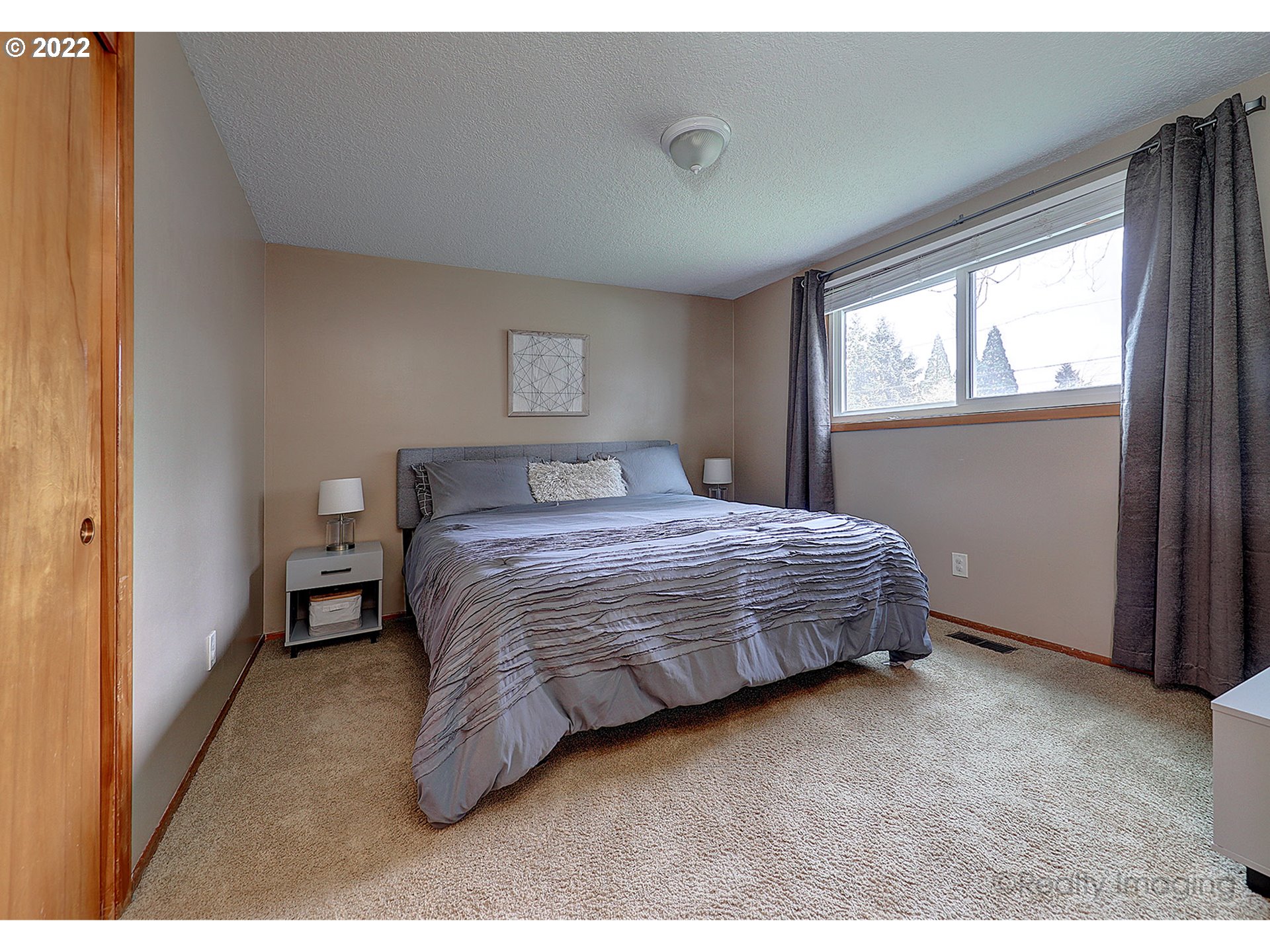 13936 Southeast Taylor Street Portland, OR 97233 - Photo 10 of 24 a bedroom with a bed and a window