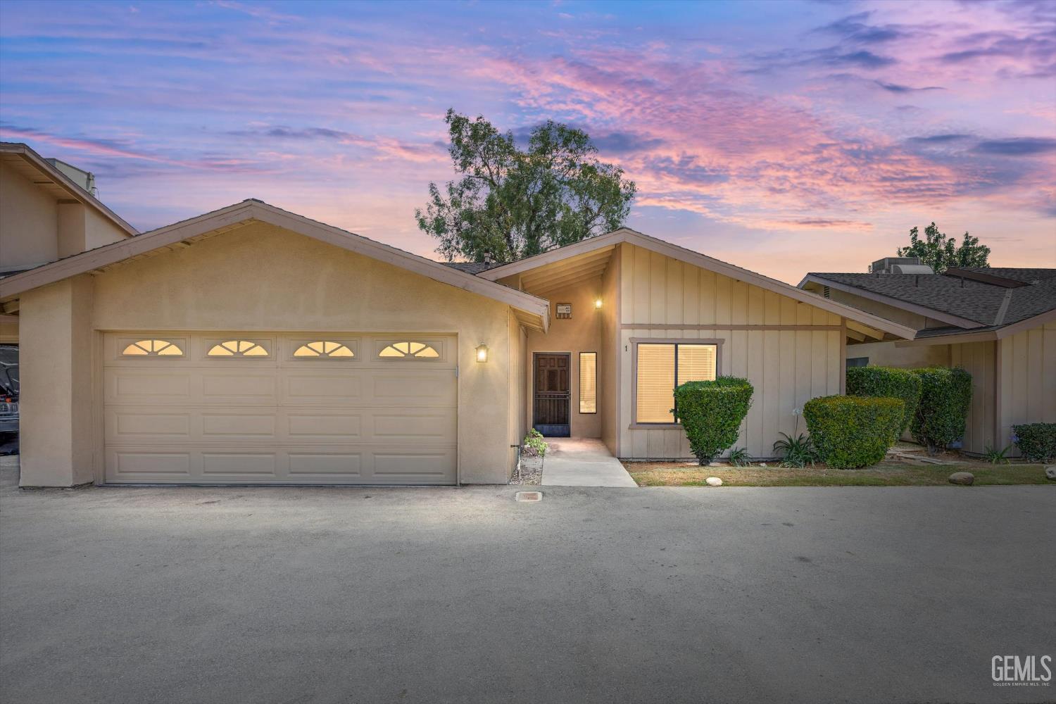 Undisclosed Address Bakersfield, CA 93308 - Photo 1 of 37 a view of a house with a garage and a yard