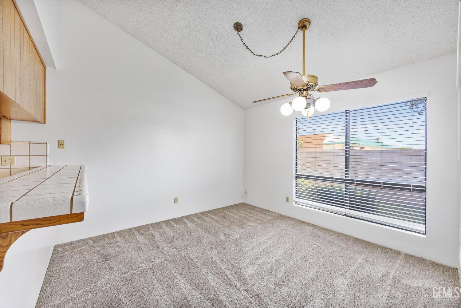 Undisclosed Address Bakersfield, CA 93308 - Photo 12 of 37 a view of a livingroom with a ceiling fan and window