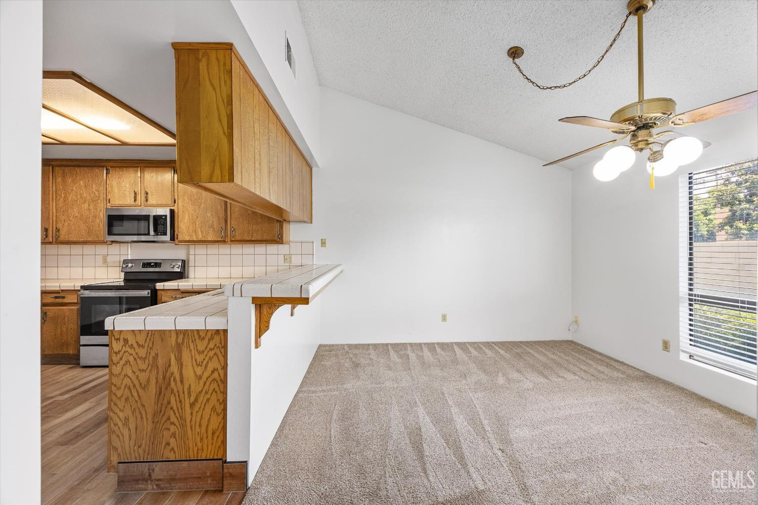 Undisclosed Address Bakersfield, CA 93308 - Photo 13 of 37 a view of a kitchen with stove and cabinets