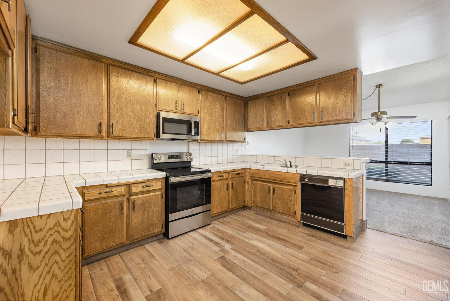 Undisclosed Address Bakersfield, CA 93308 - Photo 16 of 37 a kitchen with stainless steel appliances granite countertop a stove sink and cabinets